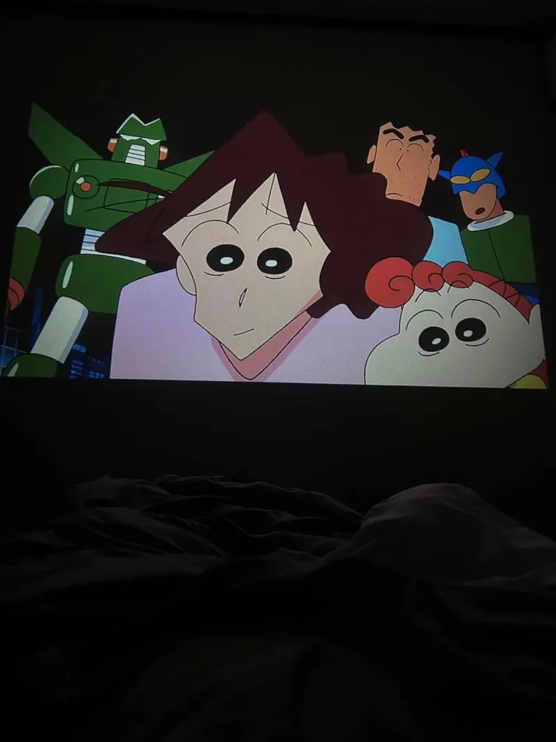 Customer photo of a cartoon projected above the bed by the VB1