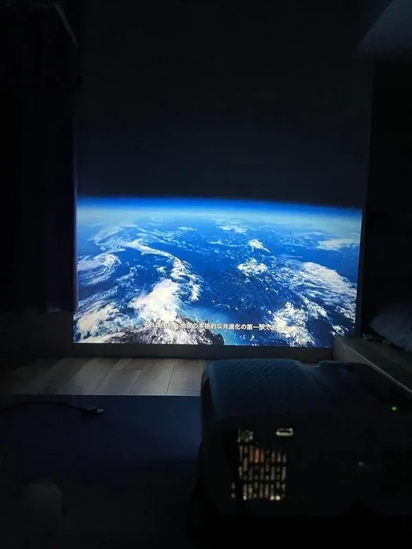 Customer photo of the VB1 projecting an earth documentary in a dark bedroom