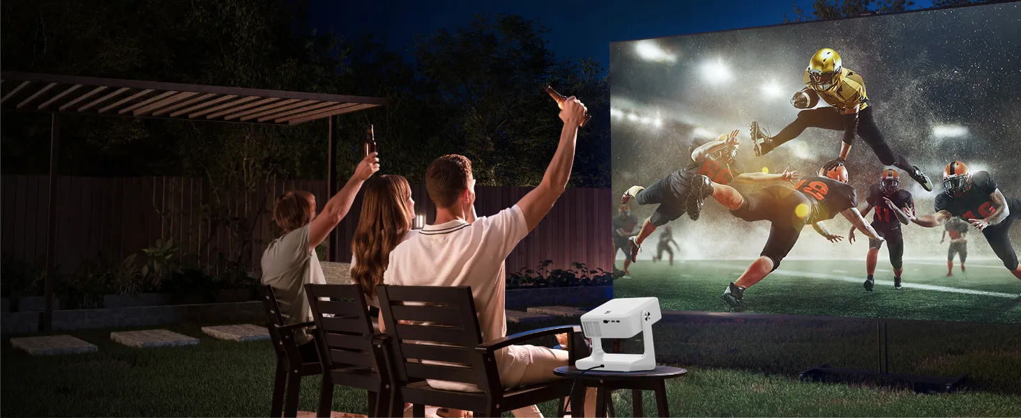 Friends cheering a football game projected in the backyard at night