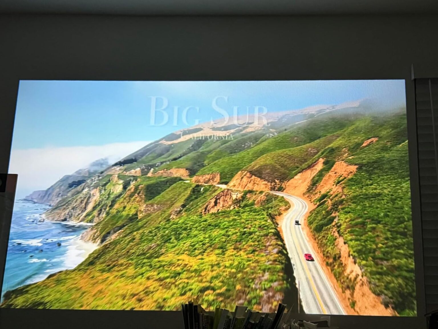 Big Sur coastline projected on a bedroom wall by the S61Pro