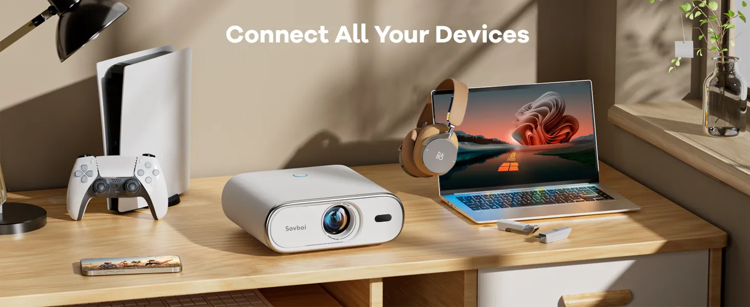 E30MAX on a desk beside a game console, laptop and headphones